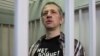 Russian journalist Roman Ivanov, wearing a T-shirt that reads "No war," stands inside a defendant's cage after being sentenced to seven years in prison for criticizing the Ukrainian offensive in social media posts, in Korolyov, Russia, on March 6, 2024.