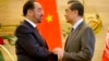 FILE - Afghan Foreign Minister Salahuddin Rabbani, left, and Chinese Foreign Minister Wang Yi, right, shake hands at the end of a joint press conference at the Ministry of Foreign Affairs in Beijing, Jan. 26, 2016.