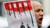 FILE - An Iranian exile shouts slogans to protest against executions in Iran during a demonstration in front of the Iranian embassy in Brussels on December 29, 2010.