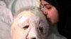 Fatima, 13, weeps as she kisses her injured father, Ahmad al-Messmar, 40, who was wounded when a deadly car bomb blew up Saturday evening near a gas station, in the predominately Shiite town of Hermel, Sunday, Feb. 2, 2014.