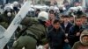 Riot police scuffle with migrants during a protest in Mytilene port on the northeastern Aegean island of Lesbos, Greece, Feb. 4, 2020. 
