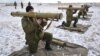 FILE- Ukrainian soldiers perform weapons exercise at training ground outside Lviv, western Ukraine, Feb. 5, 2015.