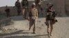 FILE - A U.S. Marine patrols a village while on a joint mission with Afghan National Army soldiers to clear the town of Taliban insurgents in the Helmand province of Afghanistan, Aug. 13, 2009. 