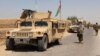 FILE - Afghan National Army troops arrive in the Nad Ali district of southern Helmand province, Aug. 10, 2016. An overnight airstrike in the area reportedly has killed at least 24.
