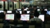 FILE - Customers surf the Internet at an Internet cafe in Beijing, China.