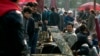 FILE - Uighur jade vendors sell their wares at an outdoor curio market where Chinese police have been checking their IDs everyday since a vehicle attack in Beijing, China.
