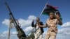 FILE - Libyan militias from towns throughout the country's west parade through Tripoli, Libya, Feb. 14, 2012.