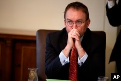 FILE - Acting White House Chief of Staff Mick Mulvaney listens during a cabinet meeting at the White House in Washington, Jan. 2, 2019.