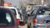 An Afghan woman asks for alms from driver on a street in Kabul, Afghanistan, Jan. 27, 2016.