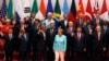 U.S. President Barack Obama, front row third from left, Chinese President Xi Jinping, second from right, and other leaders wave as they pose for a group photo session for the G-20 Summit held at the Hangzhou International Expo Center.