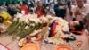 FILE - In this July 11, file photo, the body of Cambodian government critic Kem Ley is covered by the Cambodian National flag as flowers are placed during a funeral ceremony in Phnom Penh, Cambodia. Oeut Ang, the man who allegedly shot dead Kem over what 