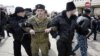 Pro-Russian volunteers stand guard in front of Crimea's parliament building during a pro-Russian rally in Simferopol, March 6, 2014.
