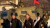 Archbishop Clement of Ukrainian Orthodox church (center) walks past a pro-Russian armored vehicle and soldiers outside an Ukrainian military base in Perevalne, Ukraine, March 15, 2014. 