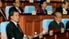 Cambodian Prime Minister Hun Sen, left, sits inside the session hall of the National Assembly with lawmakers from his Cambodian People's Party, in Phnom Penh, Cambodia, Sept. 24, 2013.