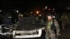 Lebanese army soliders stand guard near damages after a suicide bomber blew himself up in a passenger van in the Choueifat district southern Beirut, Lebanon, Feb. 3, 2014