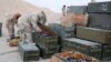 Islamic State fighters search weapon boxes in a Russian base in what is said to be Palmyra, Syria, in this still image taken from video uploaded to social media on Dec. 13, 2016.