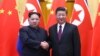 North Korean leader Kim Jong Un and Chinese President Xi Jinping shake hands