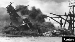 The battleship USS Arizona sinks after being hit by a Japanese air attack on Pearl Harbor, Hawaii, Dec. 7, 1941. 