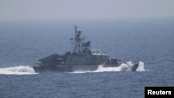 FILE - One of the five military vessels from Iran's Revolutionary Guard Corps that approached a U.S. warship hosting one of America's top generals on a day trip through the Strait of Hormuz, July 11, 2016.