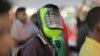 FILE - A protester wears a homemade mask for protection against potential pepper spray or teargas as thousands marched in the capital Male on June 12, 2015. Police in the Maldives unleashed pepper spray on the dozens of demonstrators, which included journalists and activists.