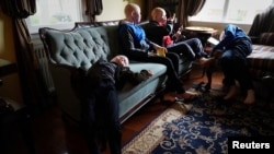 FILE - Baraka Lusambo, 7, Pendo Noni 16, Emmanuel Rutema, 15, and Mwigulu Magesaa 14, Tanzanians with albinism who had body parts chopped off in witchcraft-driven attacks, relax at a home in the Staten Island borough of New York City, June 4, 2017.