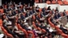The newly elected lawmakers from pro-Kurdish Peace and Democracy Party, last two rows, sit the parliament with the members of other parties in Ankara, Turkey, October 1, 2011. 