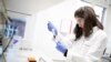An employee of the virology department of the Charite hospital prepares a test for the new coronavirus in Berlin, Germany, Jan. 21, 2020. 