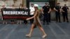 Serbian police officers guard members of the anti-war organization "Women in Black", holding a banner reading: " Srebrenica! We will never forget" as part of a protest in Belgrade, Serbia, July 6, 2015.