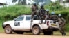 FILE - Blue-helmeted members of the U.N. Organization Stabilization Mission in the Democratic Republic of Congo sit on the back of a pickup truck in Beni, Oct. 23, 2014.