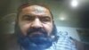 Handout photo showing Mullah Mansur at Pakistan's Federal Investigation Agency (FIA) immigration office on the Pakistan-Iran-Afghan border. He passed through the usual entry/exit booth in front of a computer, five hours before his killing.