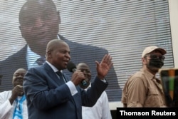 FILE - President Faustin-Archange Touadera greets supporters after highest court confirmed his re-election at his party headquarter in Bangui.