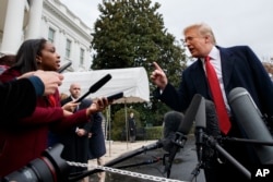 FILE - President Donald Trump takes question from reporters on the South Lawn of the White House, in Washington, Nov. 9, 2018. Trump has dismissed concerns about how Whitaker will deal with the ongoing Russia investigation.