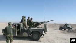 FILE - Afghan National Army soldiers guard at a checkpoint on the way to the Sangin district of Helmand province, Afghanistan, Wednesday, Dec. 23, 2015.