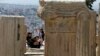 FILE - Tourists take photographs atop of the ancient Acropolis hill in Athens, May 9, 2016. Greece expects to welcome a record 27 million tourists this year.