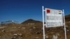 FILE - A signboard is seen from the Indian side of the Indo-China border at Bumla, in the northeastern Indian state of Arunachal Pradesh, November 11, 2009. 