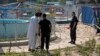 Pakistani police commandos and security personnel cordon off the area of Sunday's bombing at an amusement park in Lahore, Pakistan, March 28, 2016.