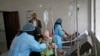 FILE - A girl, center, suspected of being infected with cholera, is treated at a hospital in Sanaa, Yemen, Sept. 9, 2019.