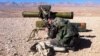 A pro-regime soldier aims a rocket launcher towards rebel locations in the Qalamoun region on the outskirts of the Syrian capital Damascus, Feb. 13, 2014. 