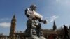 A robot is pictured in front of the Houses of Parliament and Westminster Abbey as part of the Campaign to Stop Killer Robots in London, April 23, 2013. 