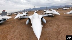 FILE - F-16 Fighting Falcons sit in a field at Davis-Monthan Air Force Base in Tucson, Arizona, May 21, 2015.