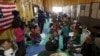 FILE - Syrian refugee children play as they wait with their families to register at the U.S. processing center for Syrian refugees, during a media tour held by the U.S. Embassy in Jordan, in Amman, Jordan, April 6, 2016.