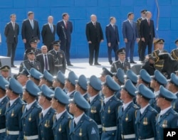 U.S. Defense Secretary James Mattis, third left, and Ukrainian officials watch a military parade to celebrate Independence Day in Kyiv, Ukraine, Aug. 24, 2017.