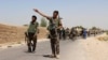An Afghan National Army (ANA) soldier gestures as they arrive in Nad Ali district of Helmand province, southern Afghanistan, Aug. 10, 2016. 