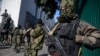 Members of a military special unit stand guard in front of a Ukrainian parliament building in Kyiv, March 17, 2014. 
