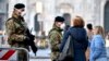 Italian soldiers wearing sanitary masks patrol Duomo square in downtown Milan, Italy, Feb. 24, 2020. 