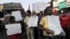 People hold placards as they campaign against nuclear power plants in Mumbai, India, April 26, 2012.