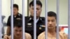 Myanmar migrants Win Zaw Htun, right, and Zaw Lin, left, both 22, are escorted by officials after their guilty verdict at court in Koh Samui, Thailand, Thursday, Dec. 24, 2015.