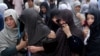 Afghan women mourn during the funeral of victims who died from a suicide attack, in Kabul, Afghanistan, Sunday, July 24, 2016. 