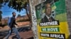 A man walks past an election poster of Jacob Zuma's African National Congress (ANC) party in the Soweto township of Johannesburg, South Africa Friday, May 9, 2014. Vote-counting in elections in South Africa is almost complete, indicating a comfortable win