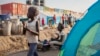 FILE - A young displaced girl washes clothes alongside a row of tents in the United Nations camp in Juba, South Sudan, Feb. 12, 2014.
